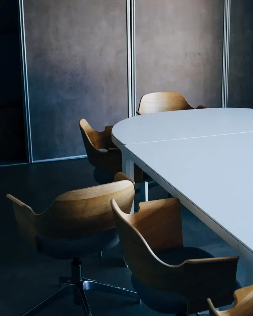 A conference table with modern chairs around it