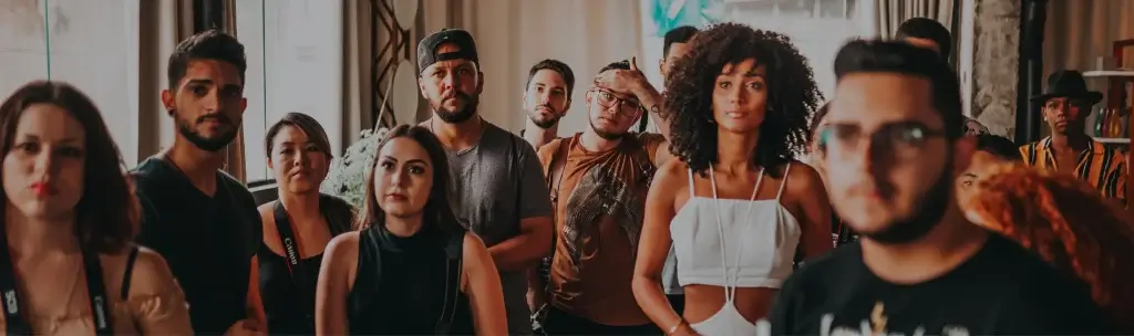 A group of people standing together looking focused in a single direction